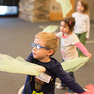 Photo of students dancing with scarves to understand mass and weight