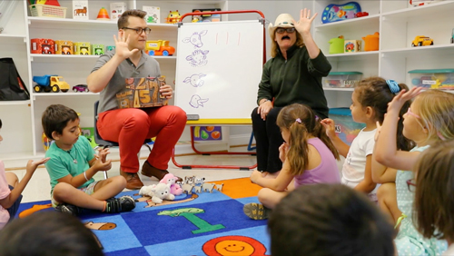 Photo of a Wolf Trap Teaching Artist and teacher working together in the classroom