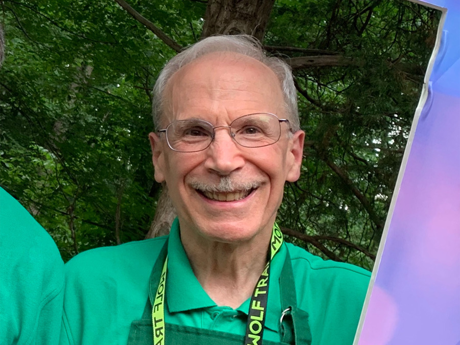 Jonathan Kosarin wearing a green Wolf Trap volunteer shirt and apron.