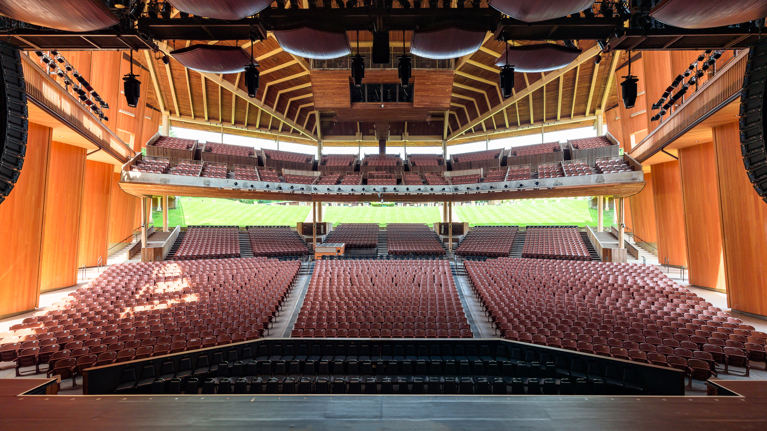 Full stage-to-audience view of renovated seating layout with clear aisles and tiered sections.