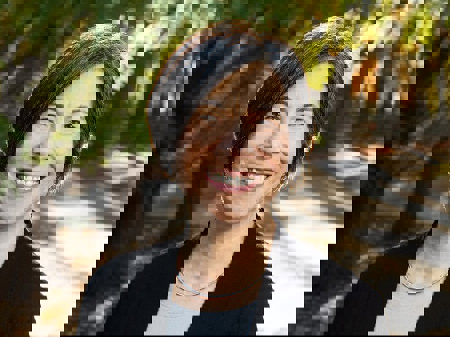 Jean Edelman surrounded by greenery.