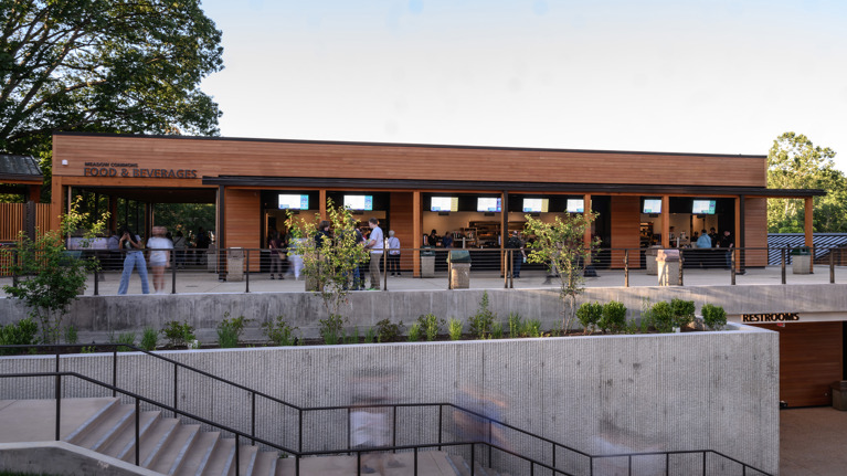 View of Meadow Commons building with food and beverage counters and modern concrete terraces.